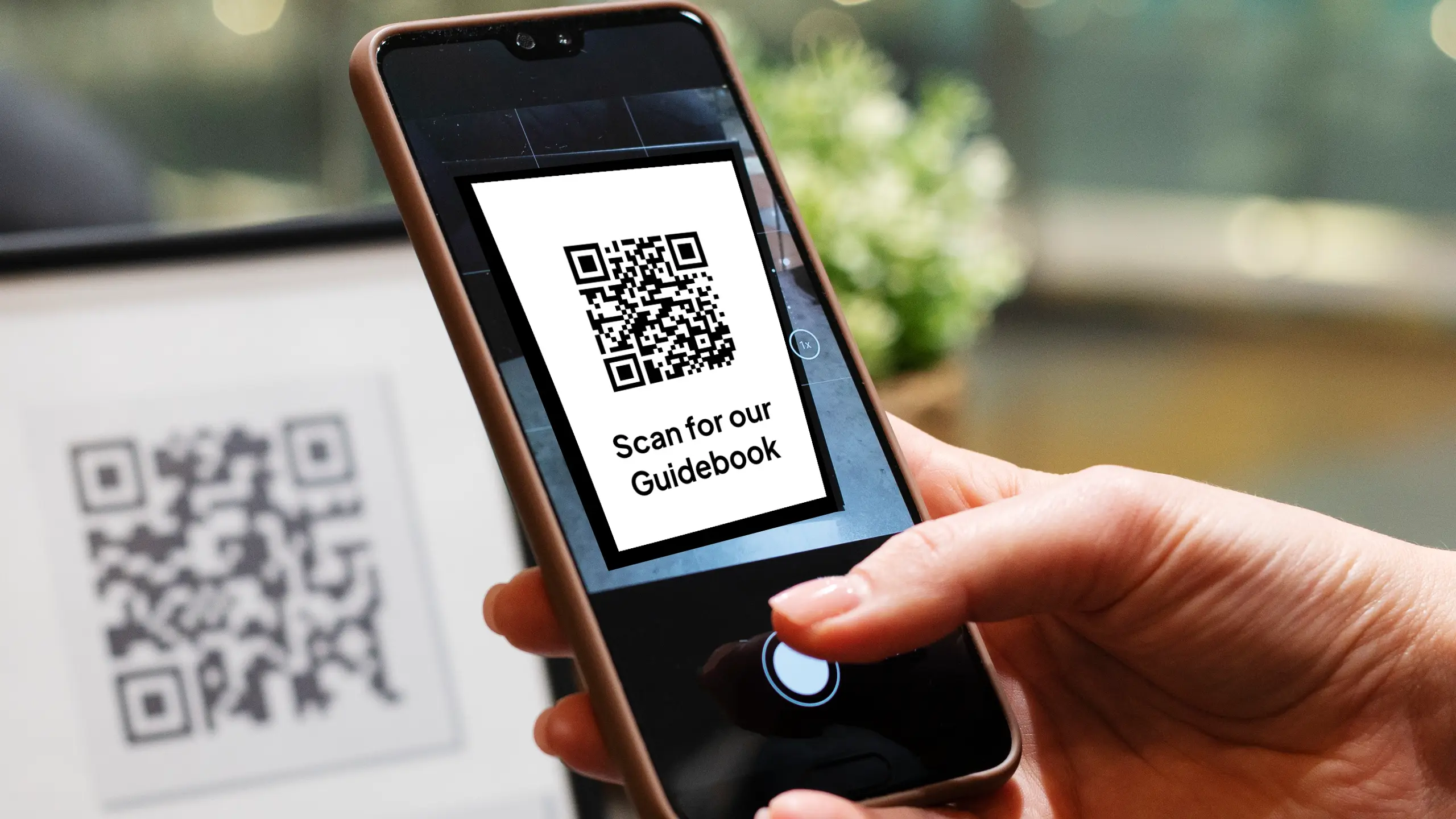 ‘A guest scanning a QR  code to access an InvoGuide guidebook’